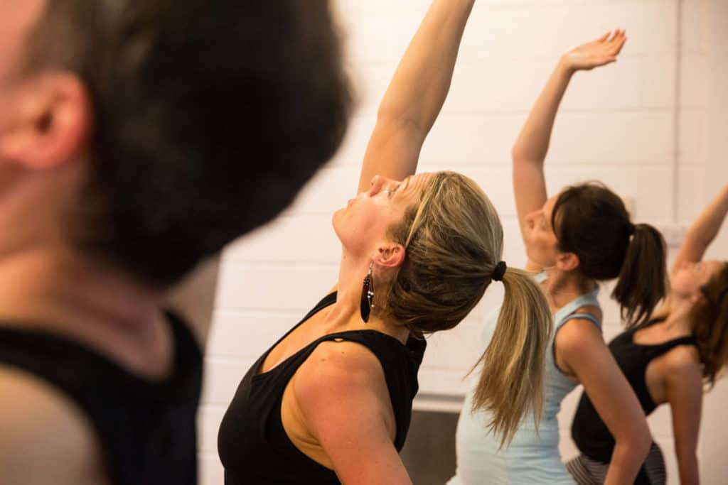 regular yoga classes can be beneficial, class in yoga position at yogafurie in bristol