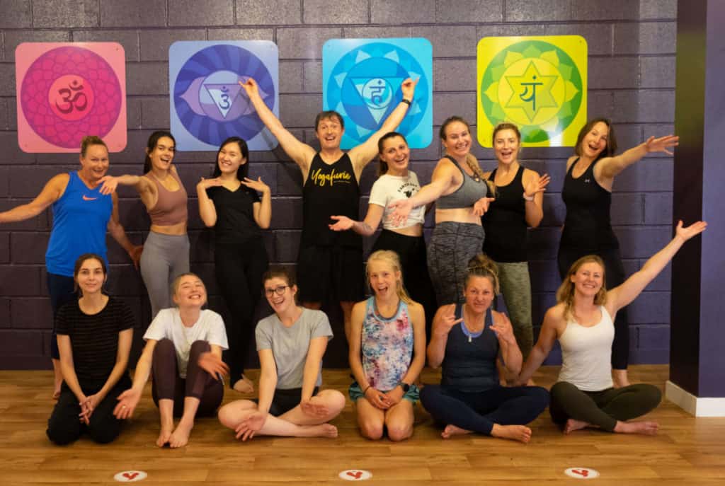 Group of yoga teacher training students all posing happily for a photo in Bristol