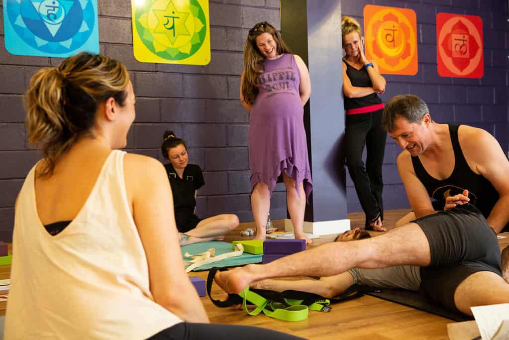 At a yoga studio in bristol, this group of yoga teacher trainees are learning about yoga anatomy and yoga poses on a 200 hour yoga teacher training course