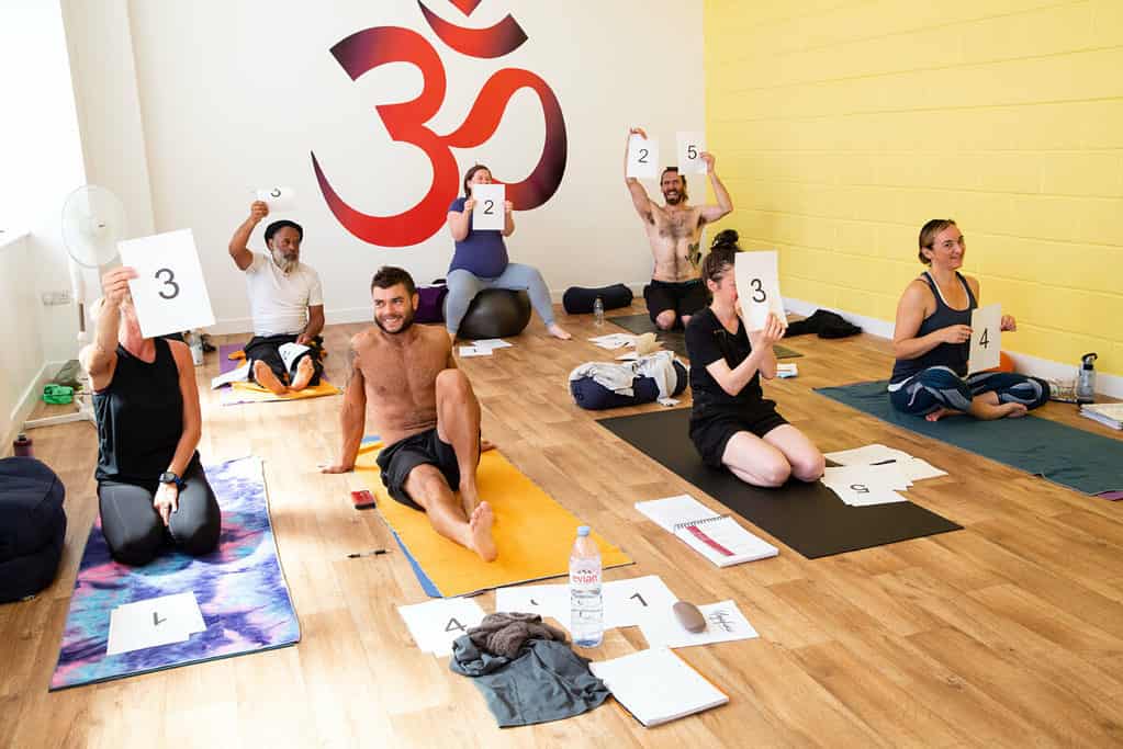 A group of students in bristol, on a yoga teacher training course, playing a game
